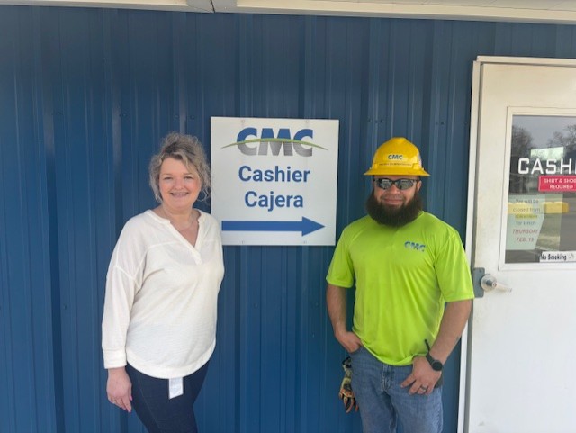 Two employees outside the Lufkin recycling building.