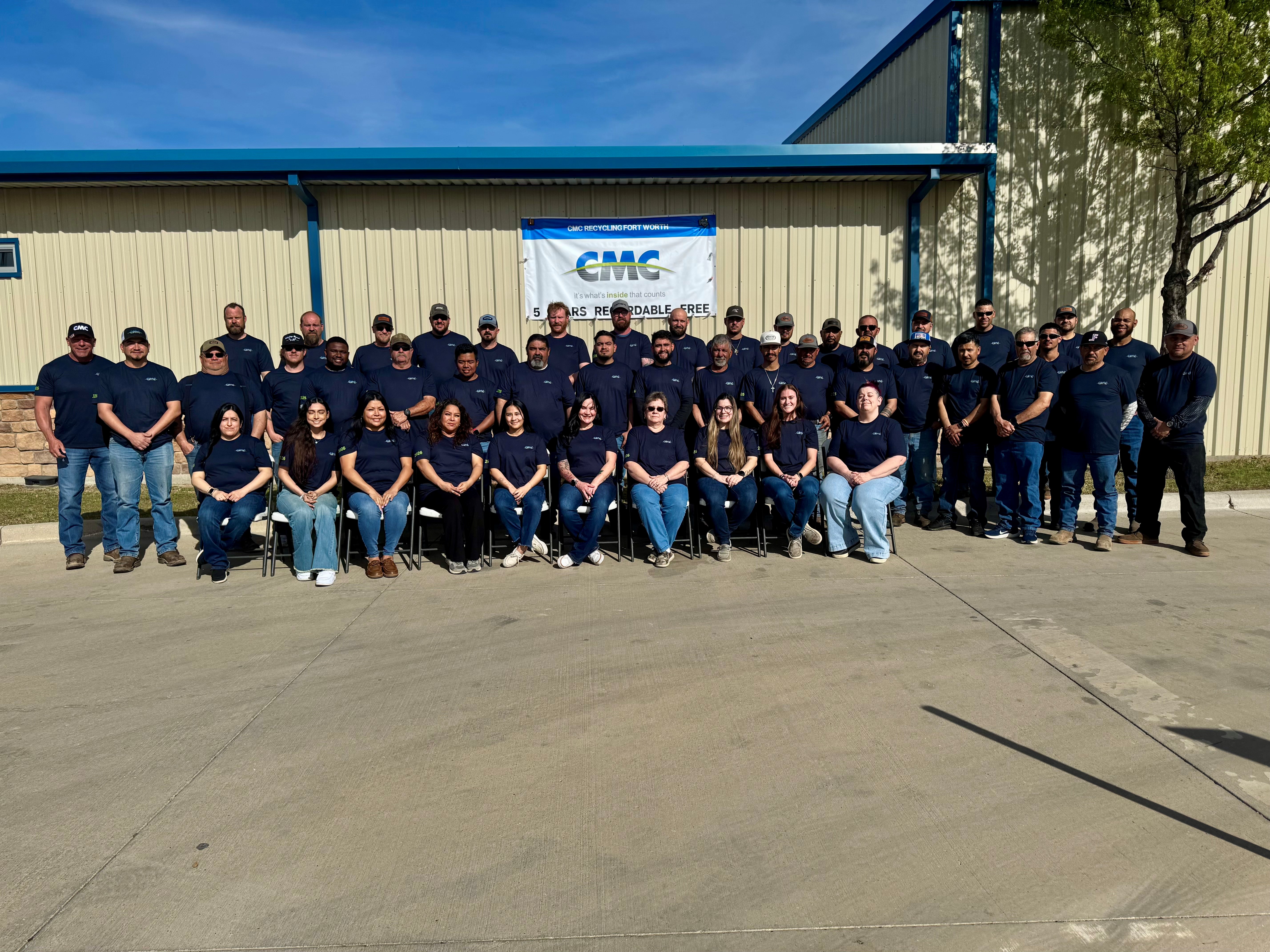 A photo inside showing a group of employees posing for the camera.